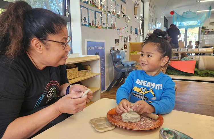 Evolve Education Teacher and preschool boy playing with clay