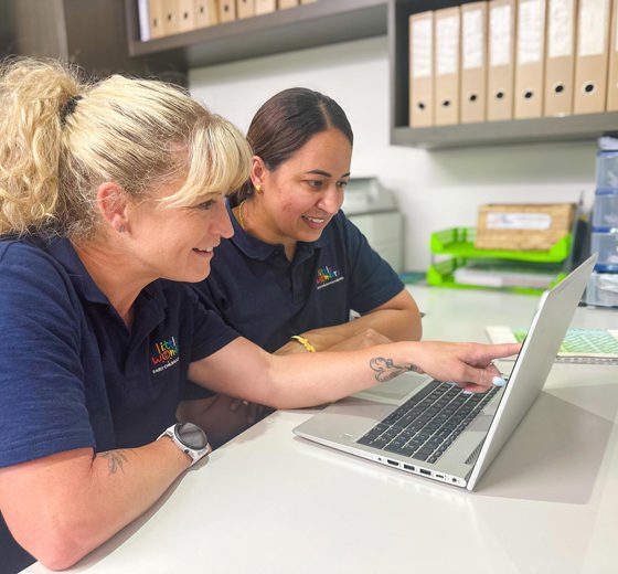 Evolve Education Teachers working together on laptop