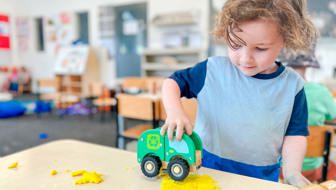 Evolve Education Preschool boy playing with care and playdough at daycare