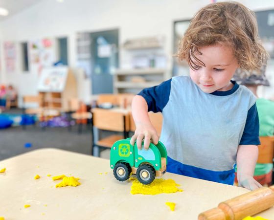 Evolve Education Preschool boy playing with care and playdough at daycare