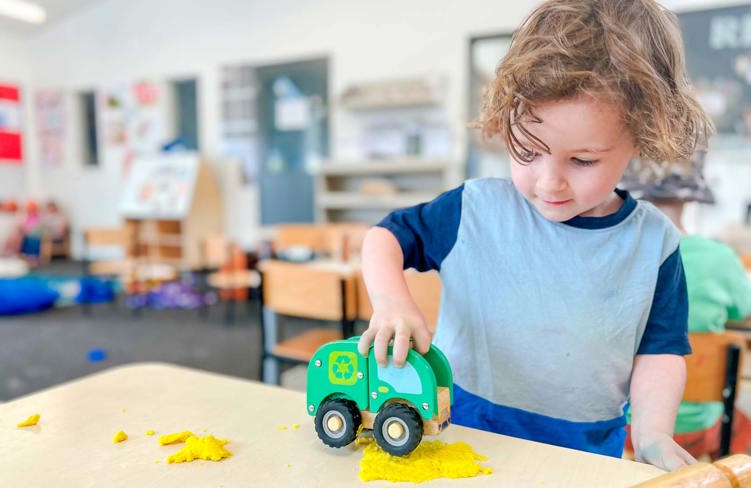 Evolve Education Preschool boy playing with care and playdough at daycare