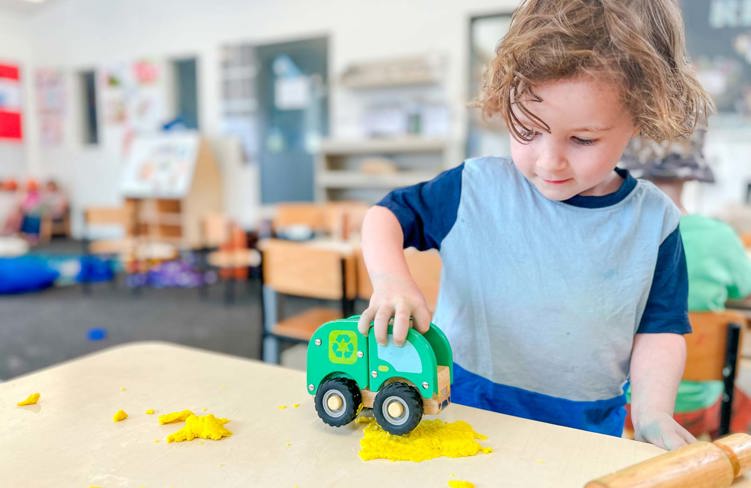 Evolve Education Preschool boy playing with care and playdough at daycare
