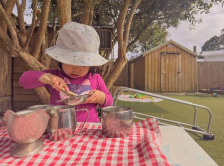 Evolve Education Preschool girl playing with tea set at daycare