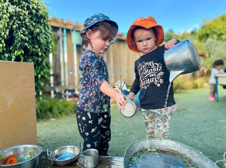 Evolve Education Preschool girls playing with water at daycare
