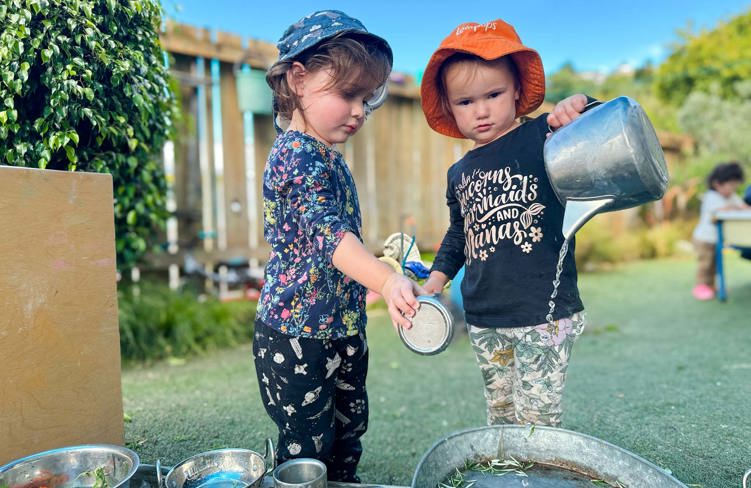 Evolve Education Preschool girls playing with water at daycare