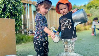 Evolve Education Preschool girls playing with water at daycare