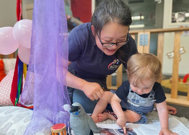 Evolve Education Teacher reading with baby