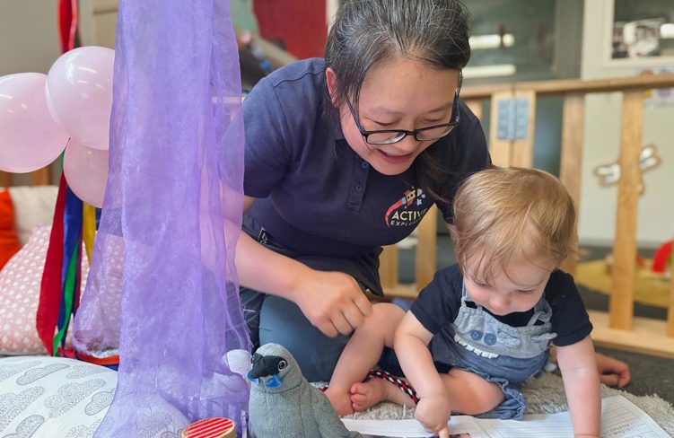 Evolve Education Teacher reading with baby