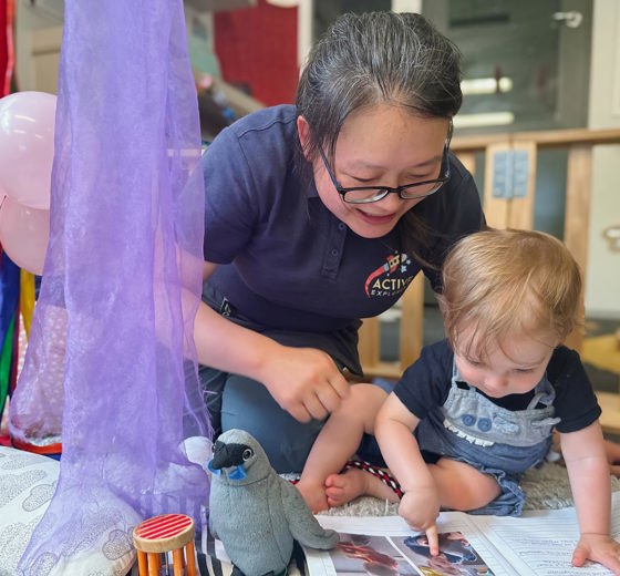 Evolve Education Teacher reading with baby