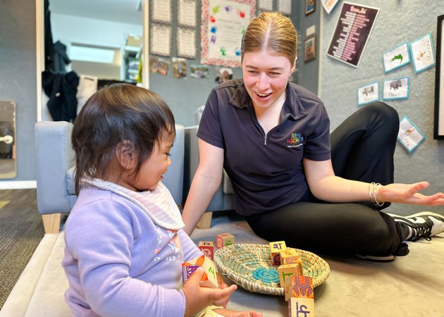 Evolve Education Teacher and baby playing with blocks