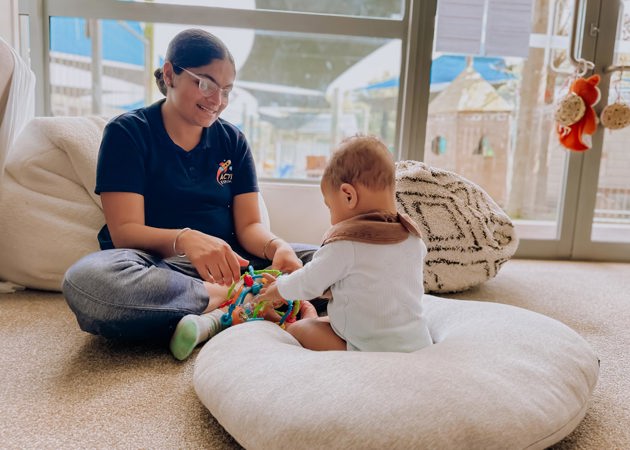 Evolve Education Teacher plays with Baby