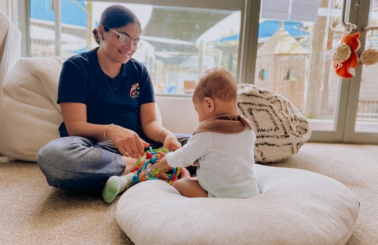 Evolve Education Teacher plays with Baby