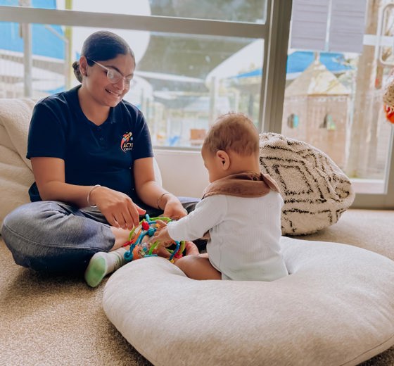 Evolve Education Teacher plays with Baby