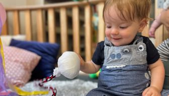 Evolve Education Baby in nursery playing with poi at daycare