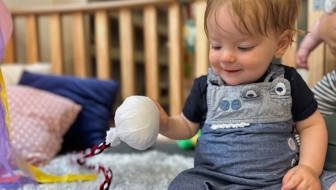 Evolve Education Baby in nursery playing with poi at daycare