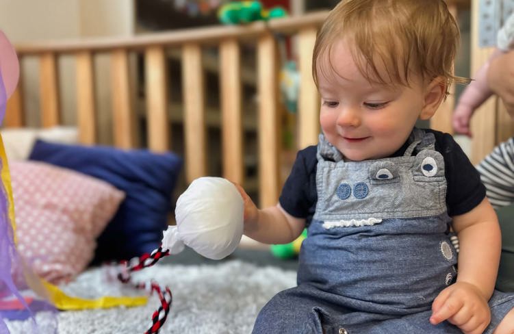 Evolve Education Baby in nursery playing with poi at daycare