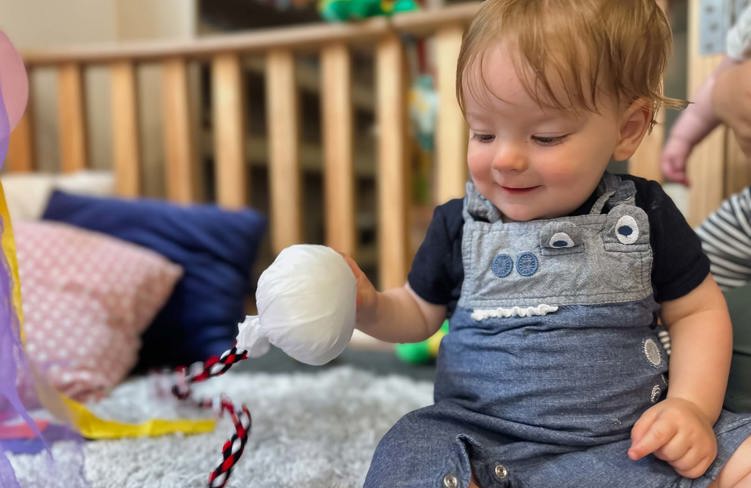 Evolve Education Baby in nursery playing with poi at daycare